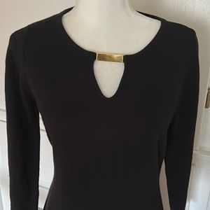Calvin Klein little black sweater dress with gold embellishment.